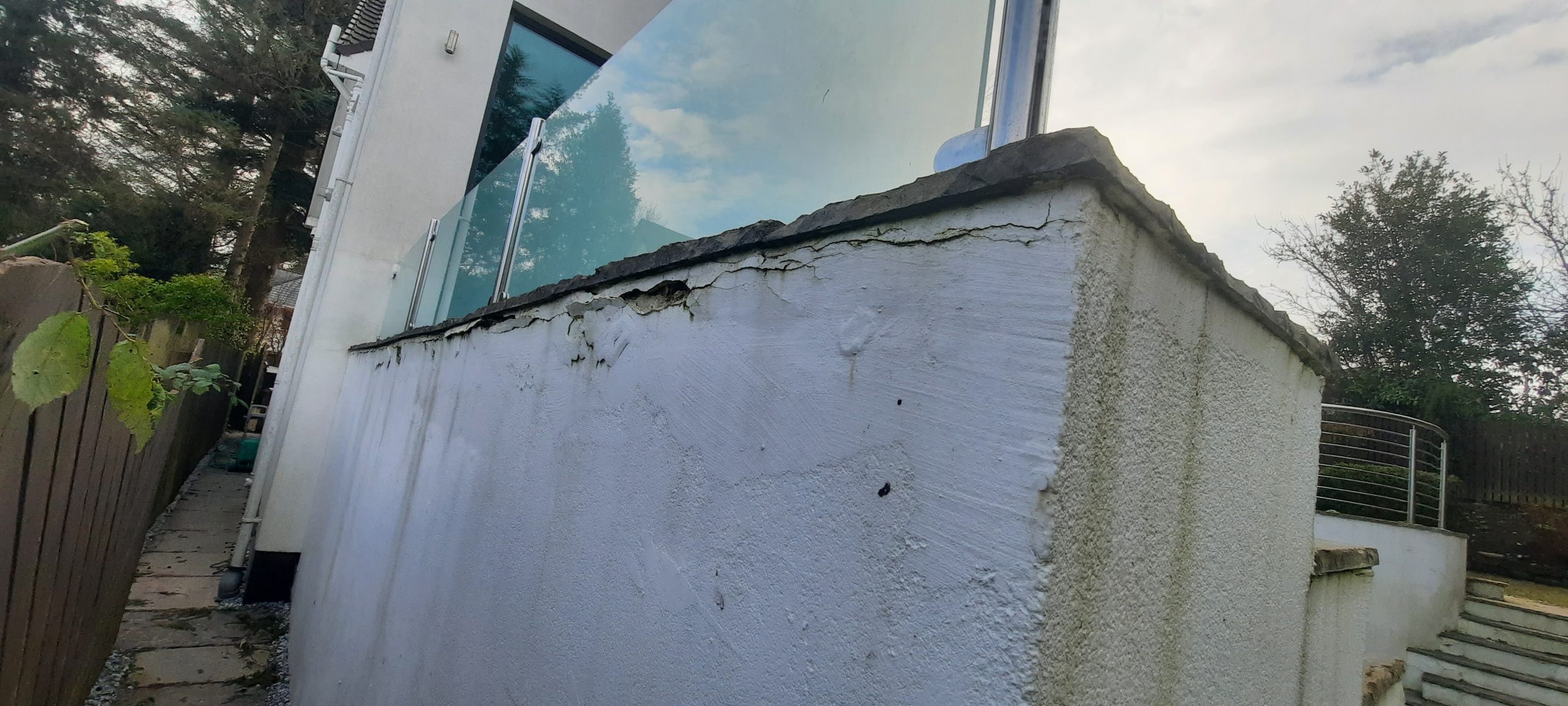 roughcast repair along angled wall edge