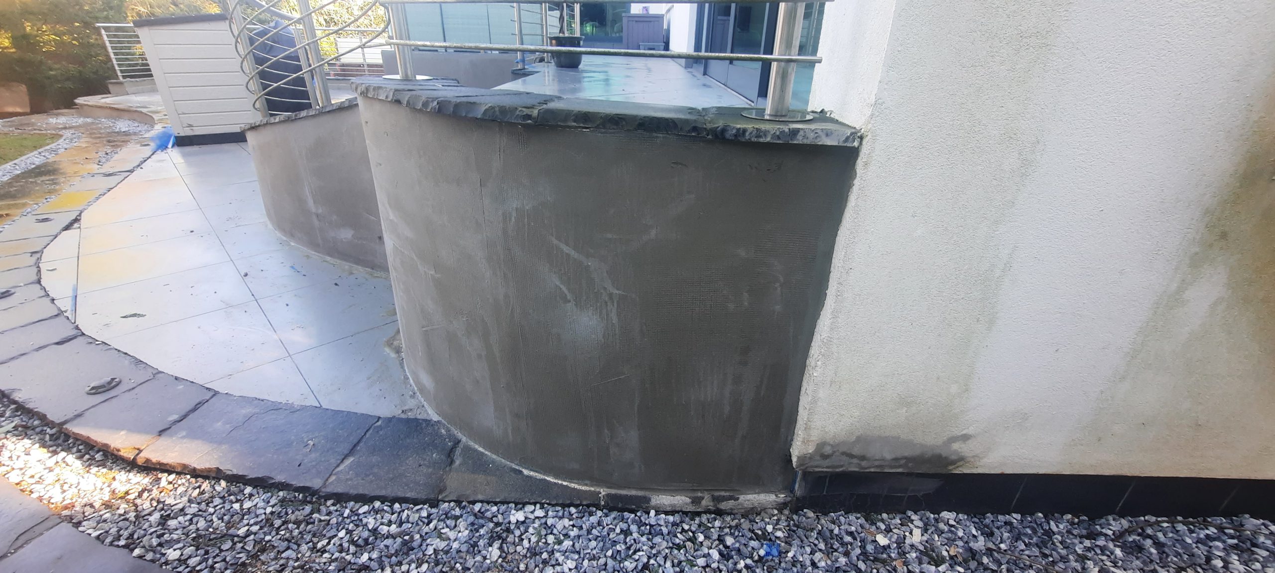 roughcast render repair on rounded exterior section