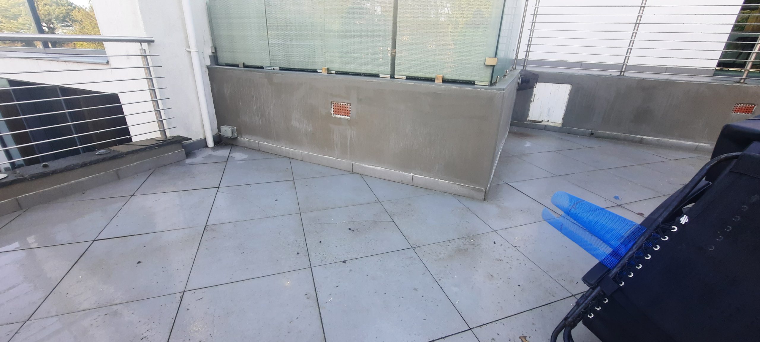 roughcast render repair on low boundary wall