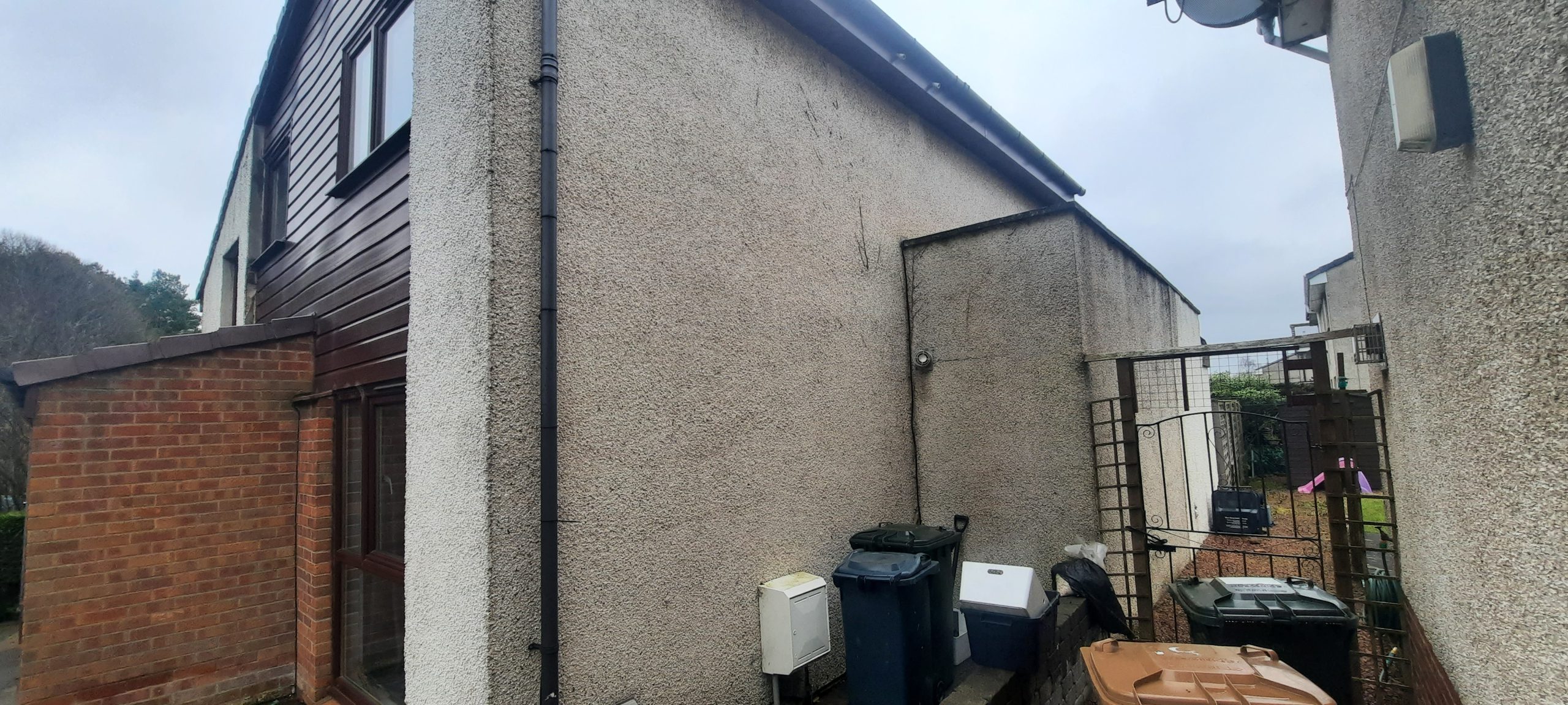 roughcast render repair on tall gable end