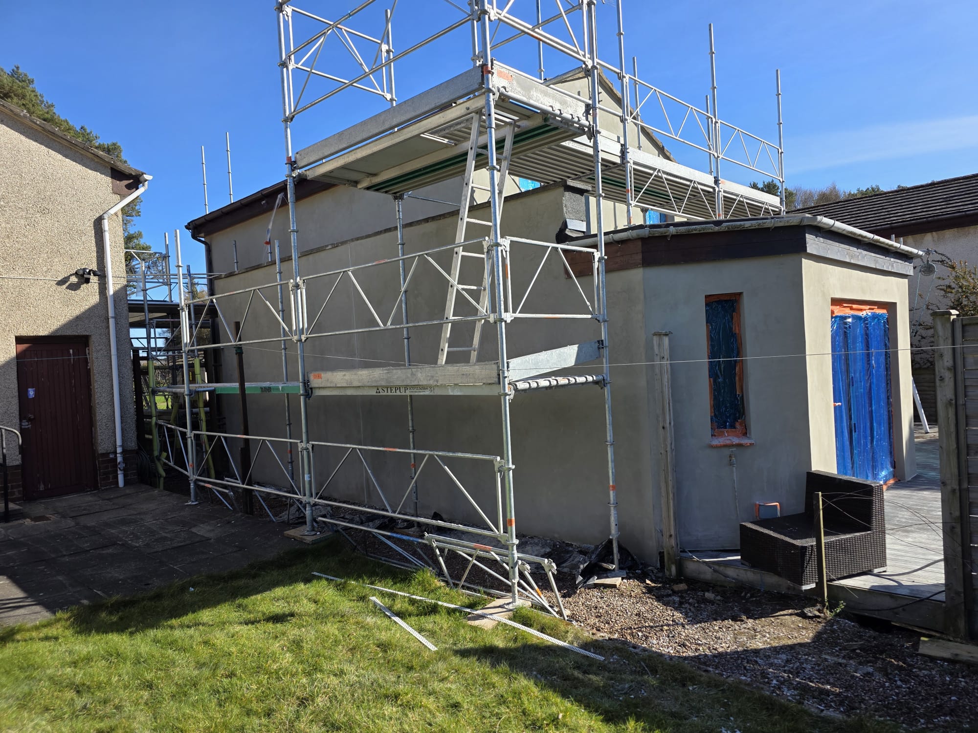 roughcast repair with tall scaffolding structure