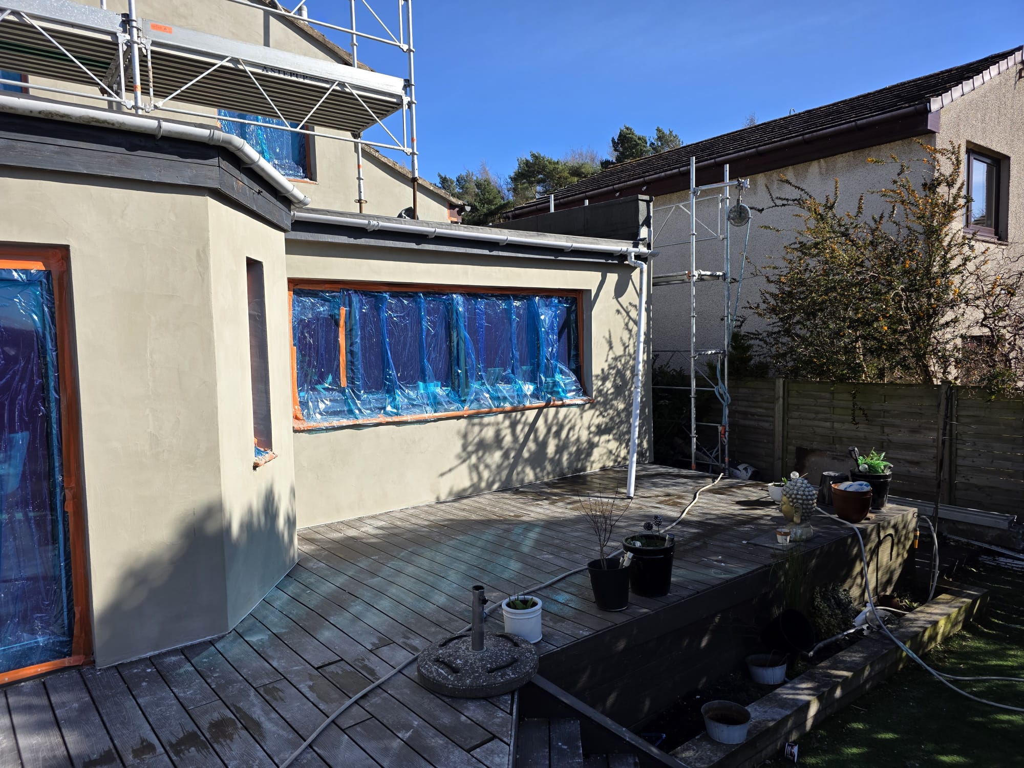 roughcaster Edinburgh applying coat near garden side