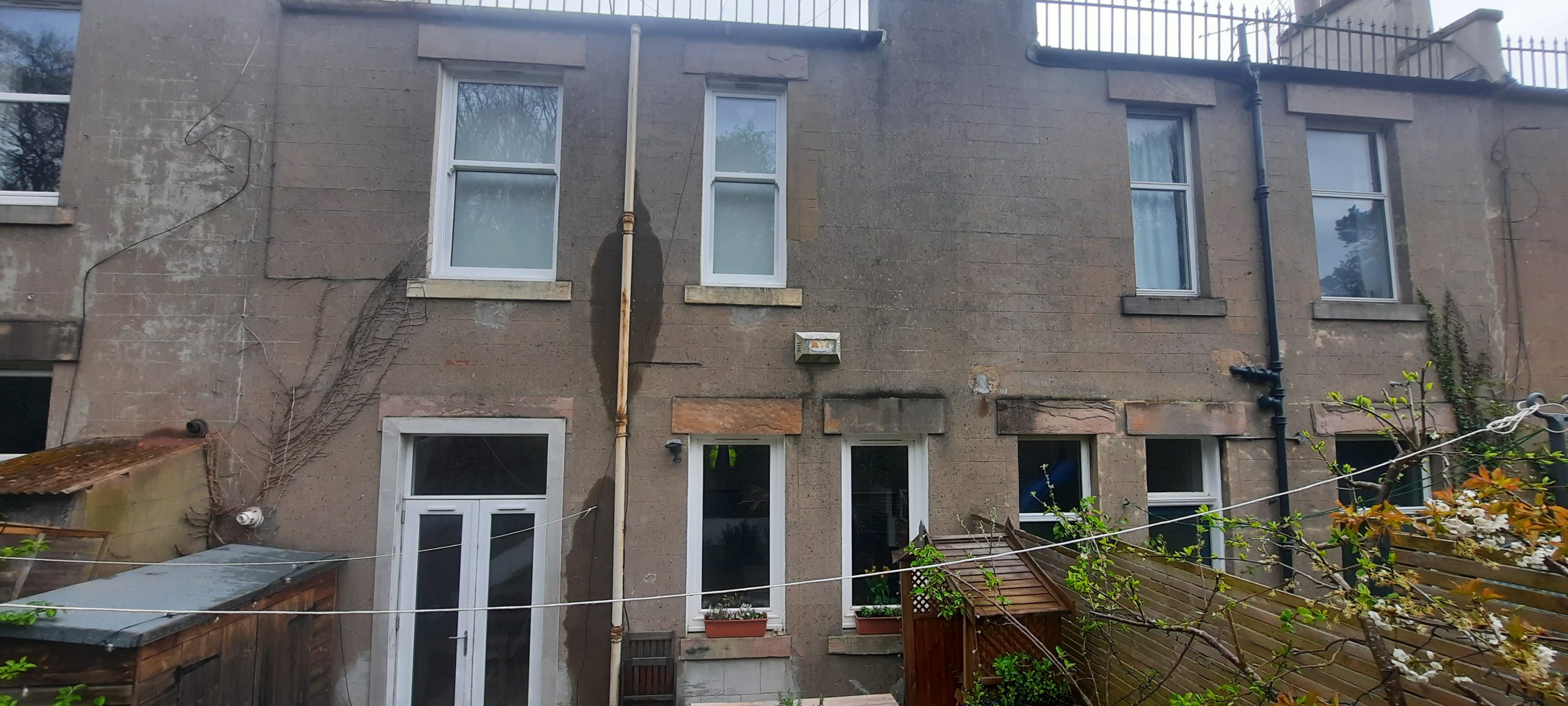 roughcast render Edinburgh on worn exterior wall