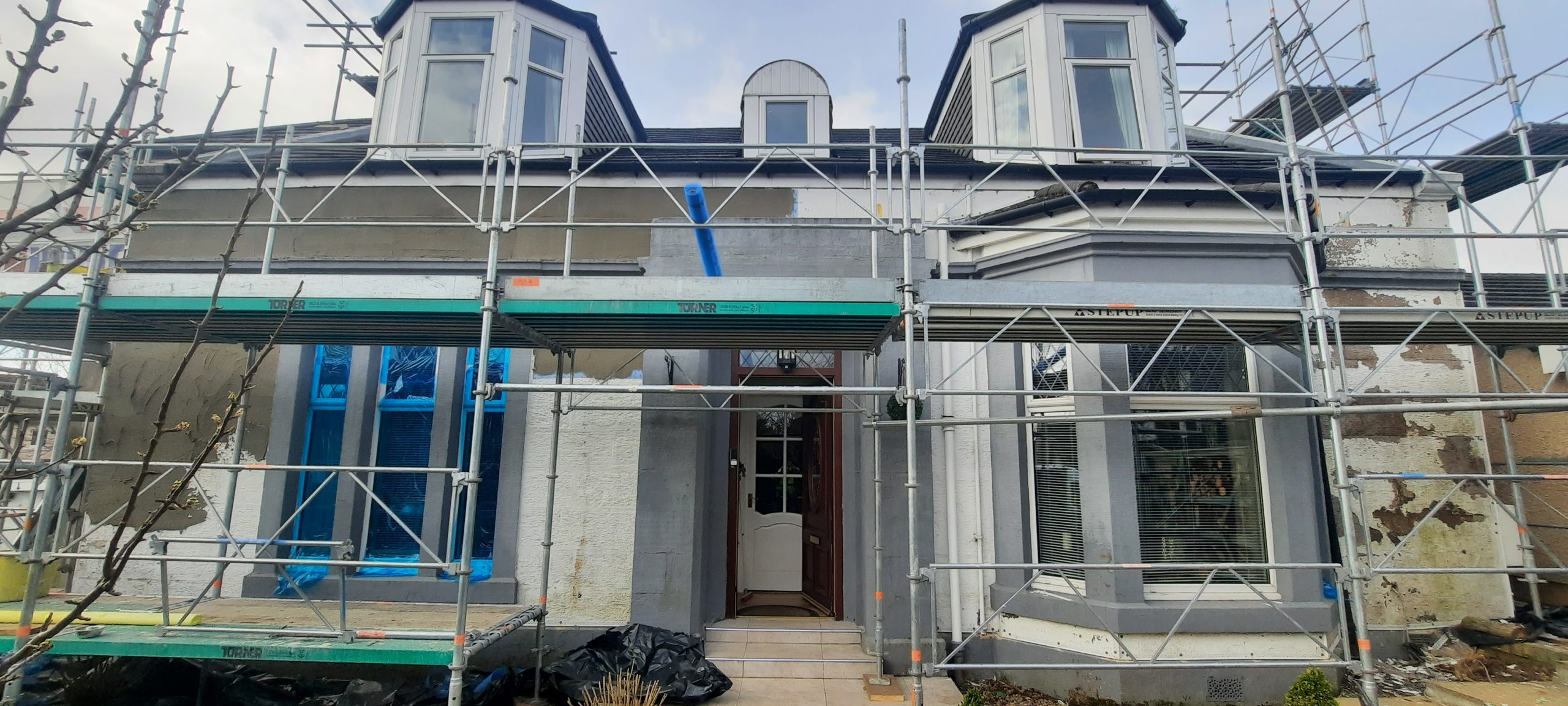 roughcast repair scaffolding at main doorway