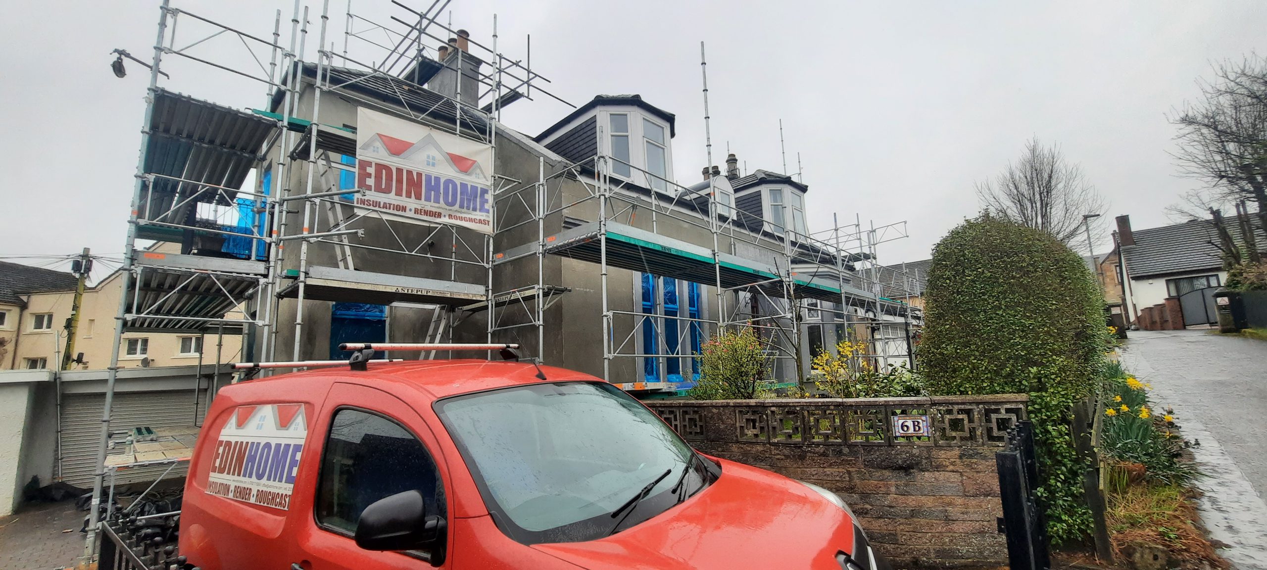 roughcaster Edinburgh working beside red car
