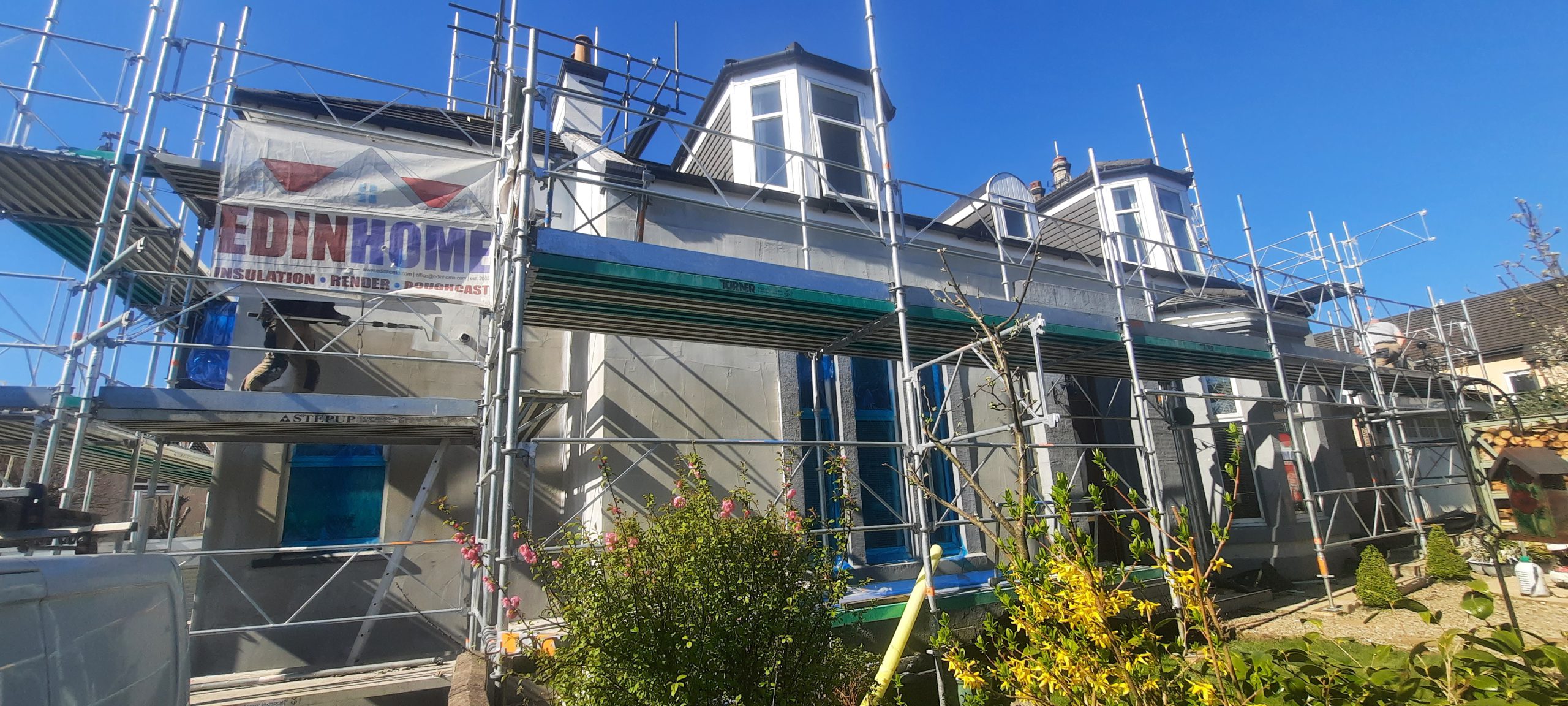 roughcast repair in progress with upper scaffolding