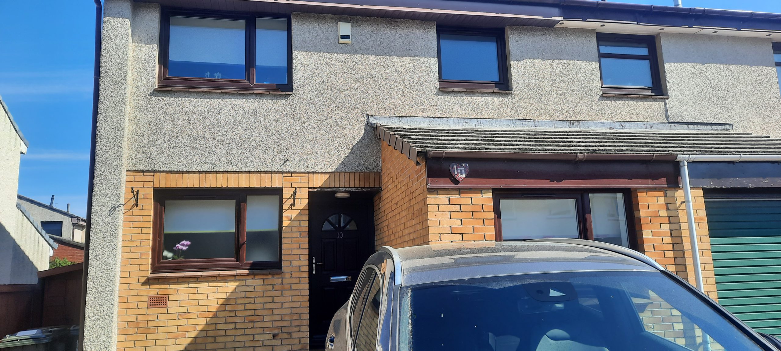front door area before roughcast render repair on upper facade