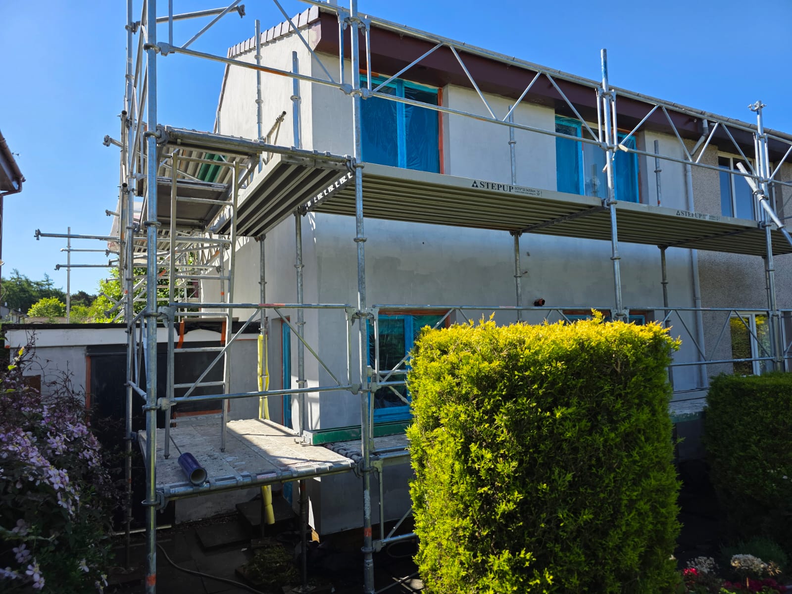 house rendering Edinburgh in progress with scaffolding and fresh base coat