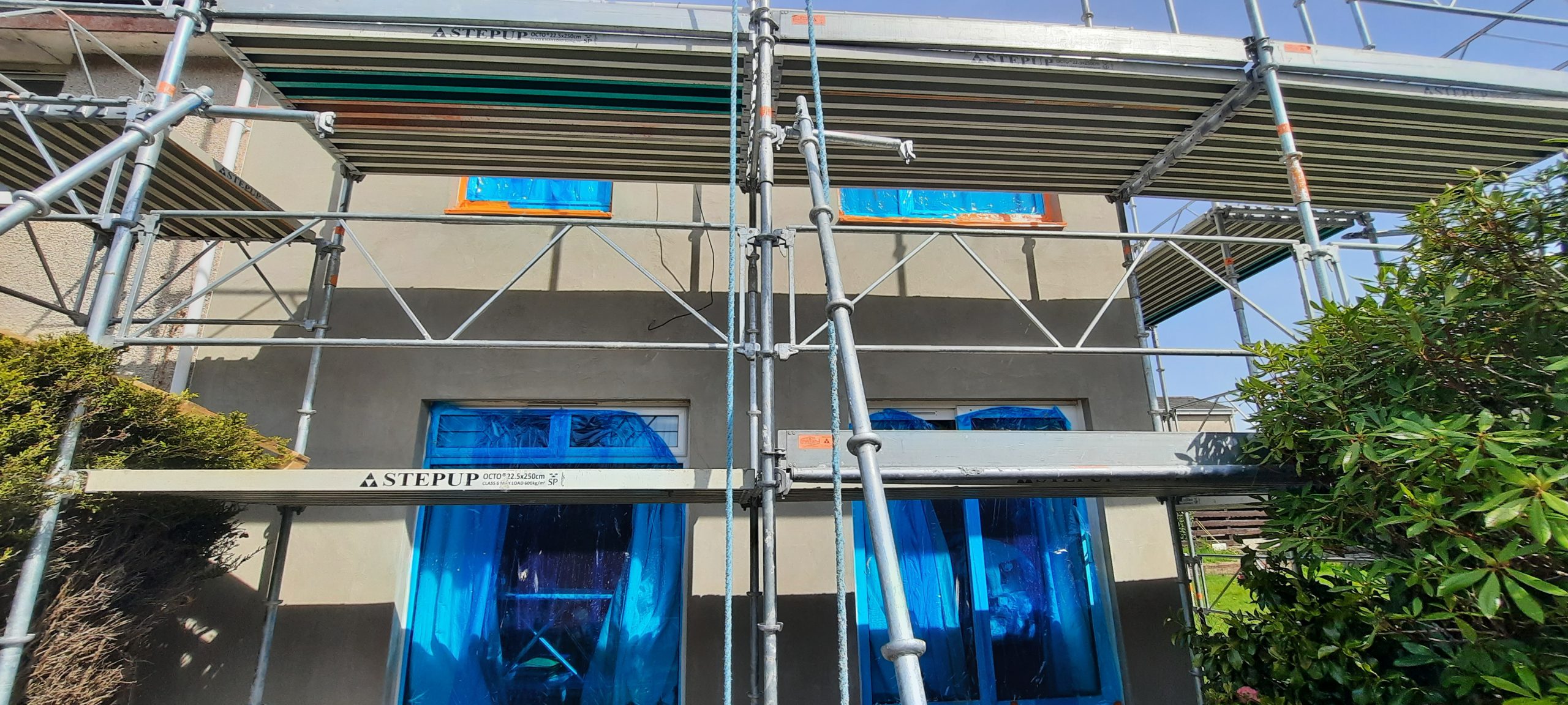 solid wall insulation Edinburgh installation underway with visible scaffolding poles
