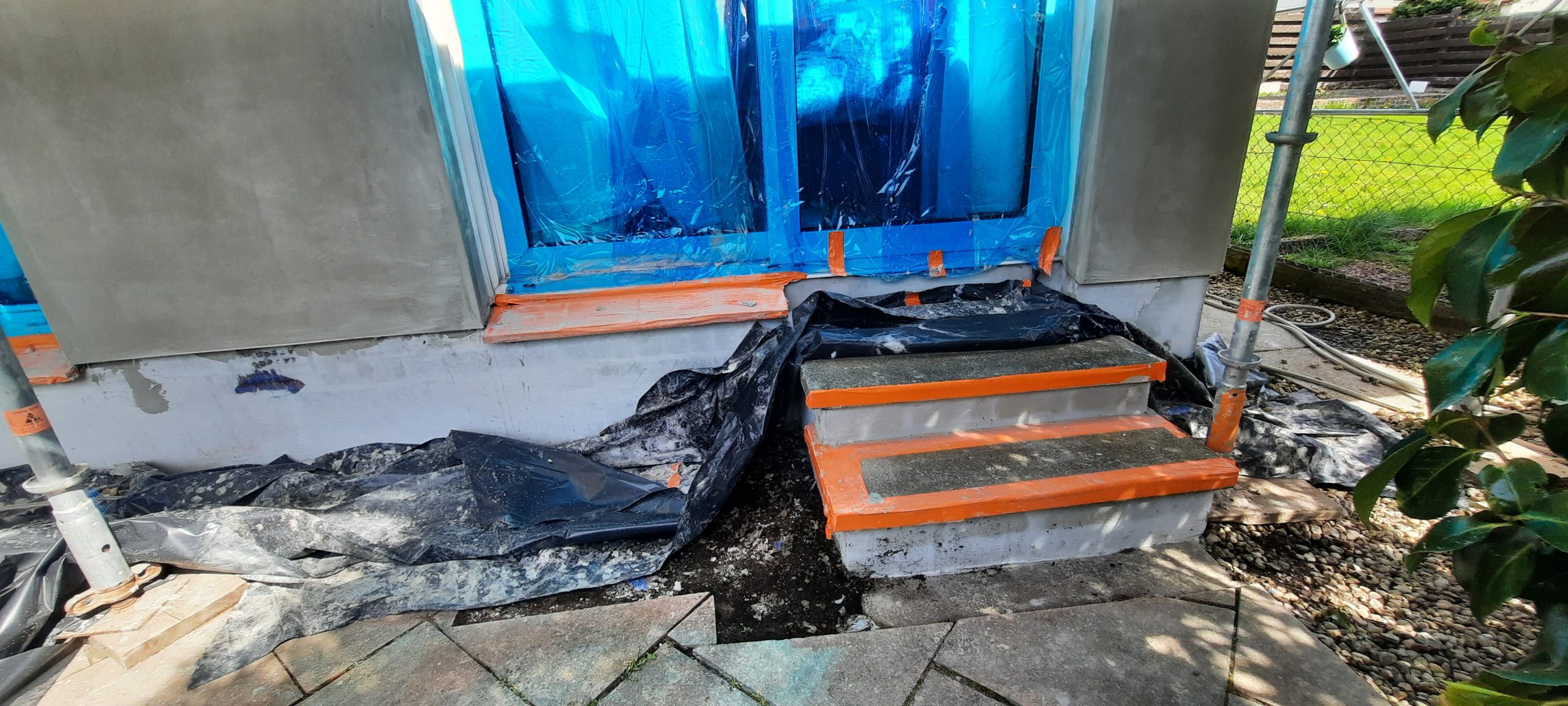 roughcast repair showing base coat around protected window sill