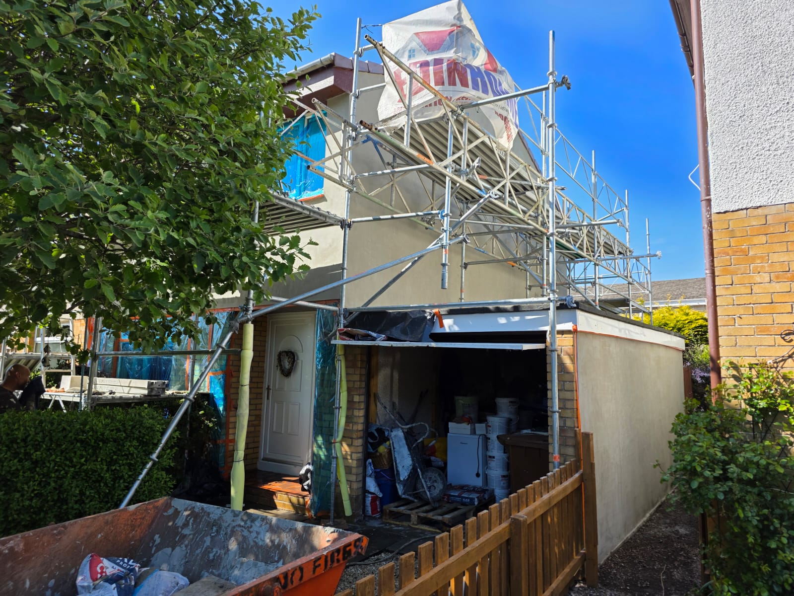 gable end of residential building with bright, new roughcast render Edinburgh