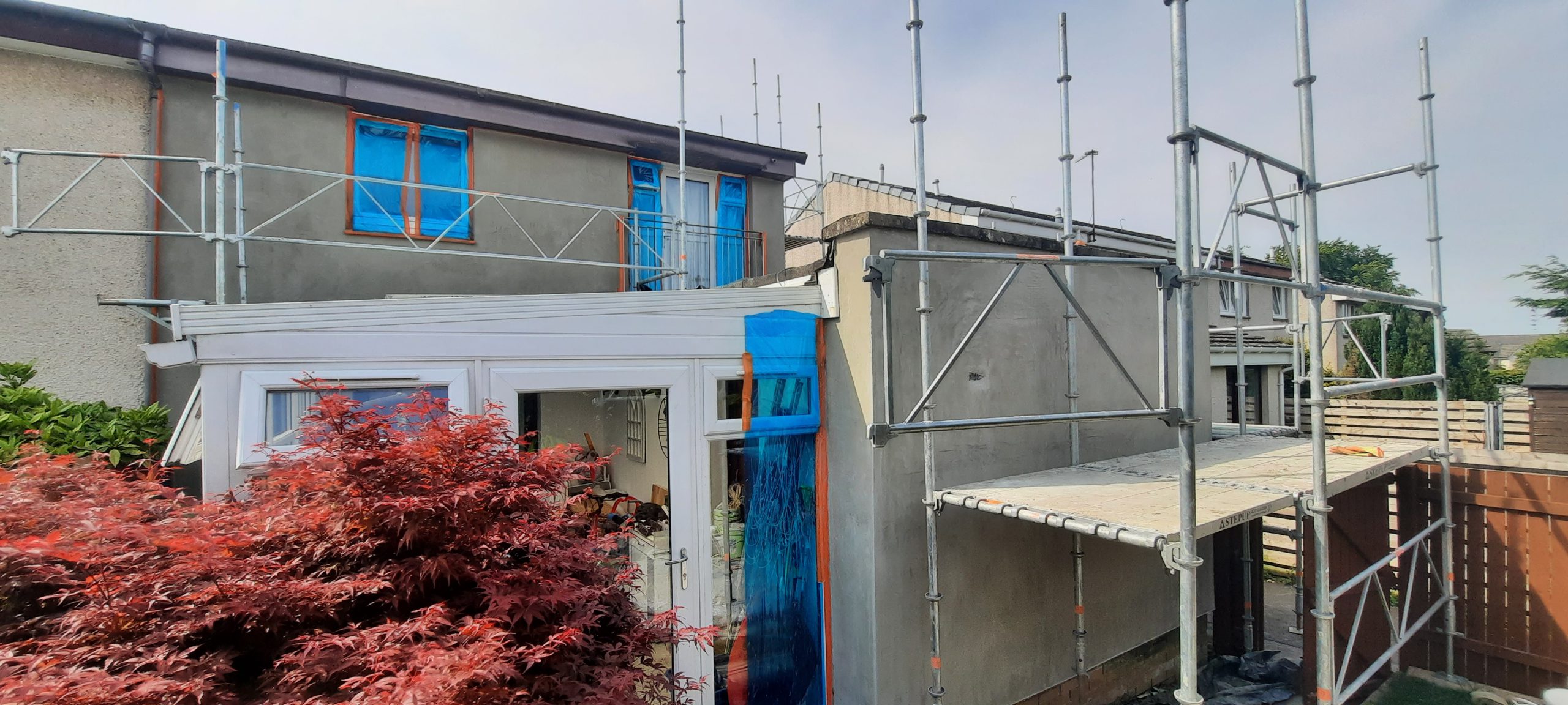 roughcasting Edinburgh applied on rear wall beside garden conservatory