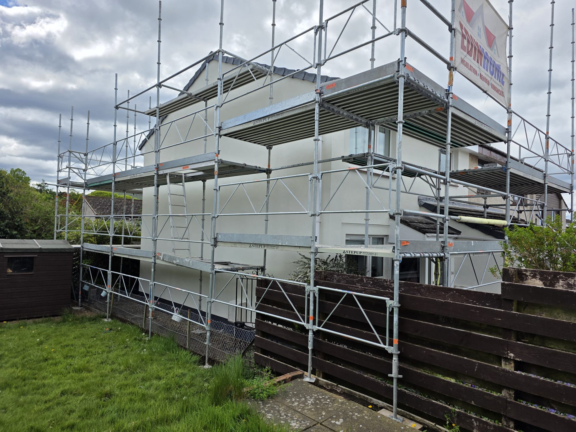 roughcasting Edinburgh on house side with protective blue window film