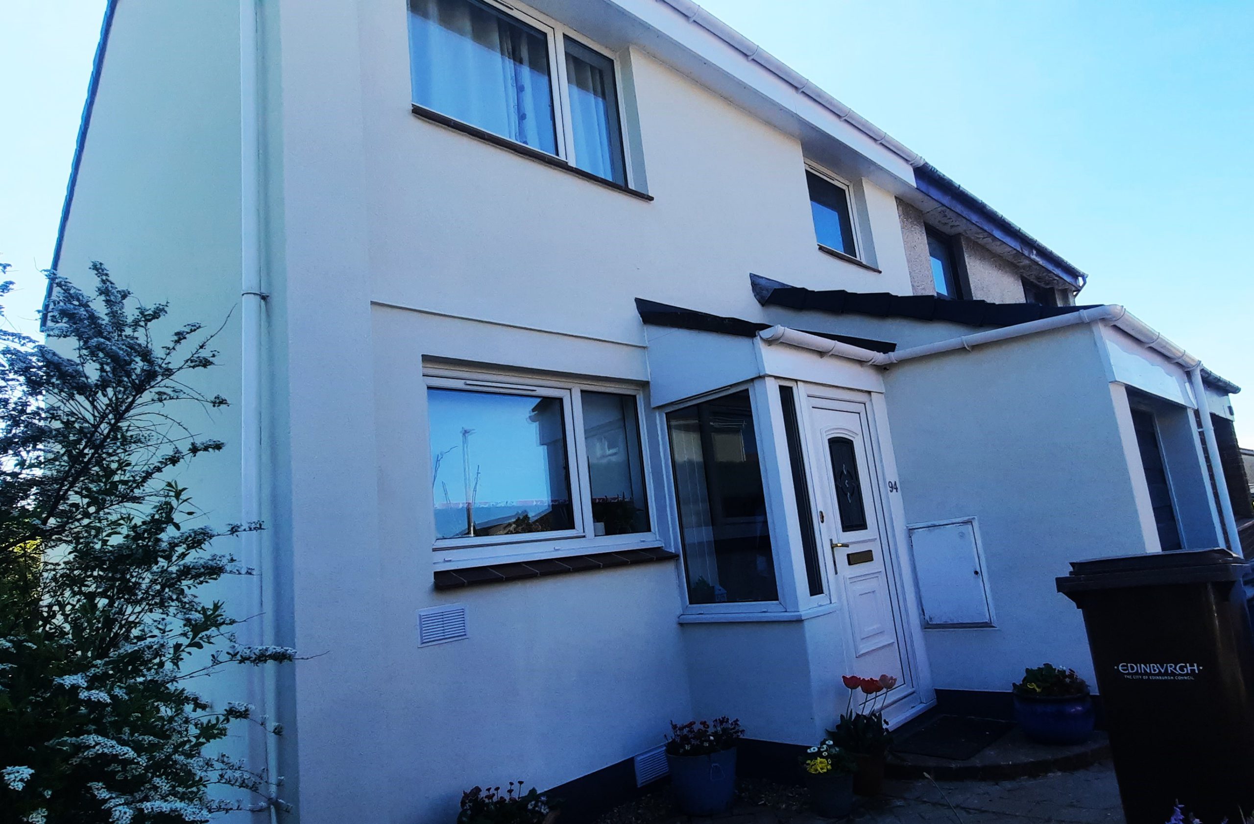 light-colored roughcasting Edinburgh on house front with porch detail