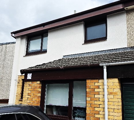 front elevation enhanced with roughcast render repair near entrance