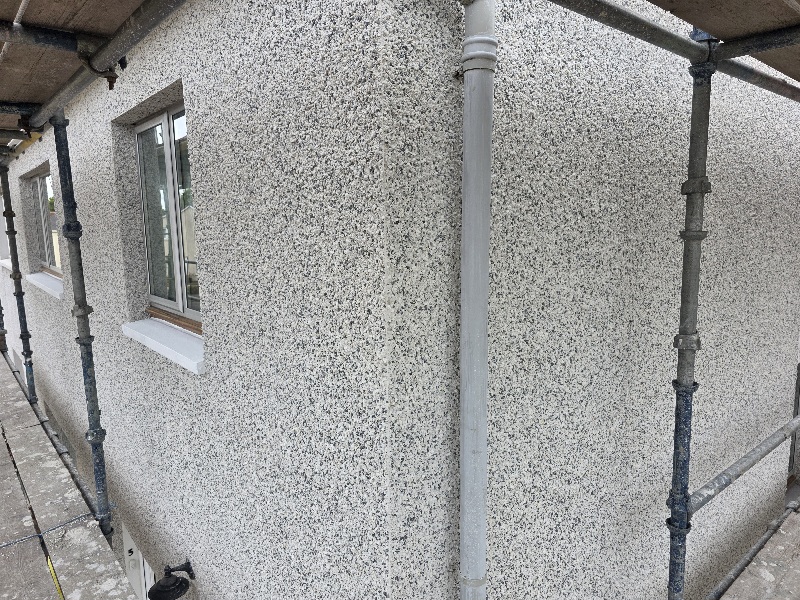 close-up detail of roughcast repair blending into existing surface